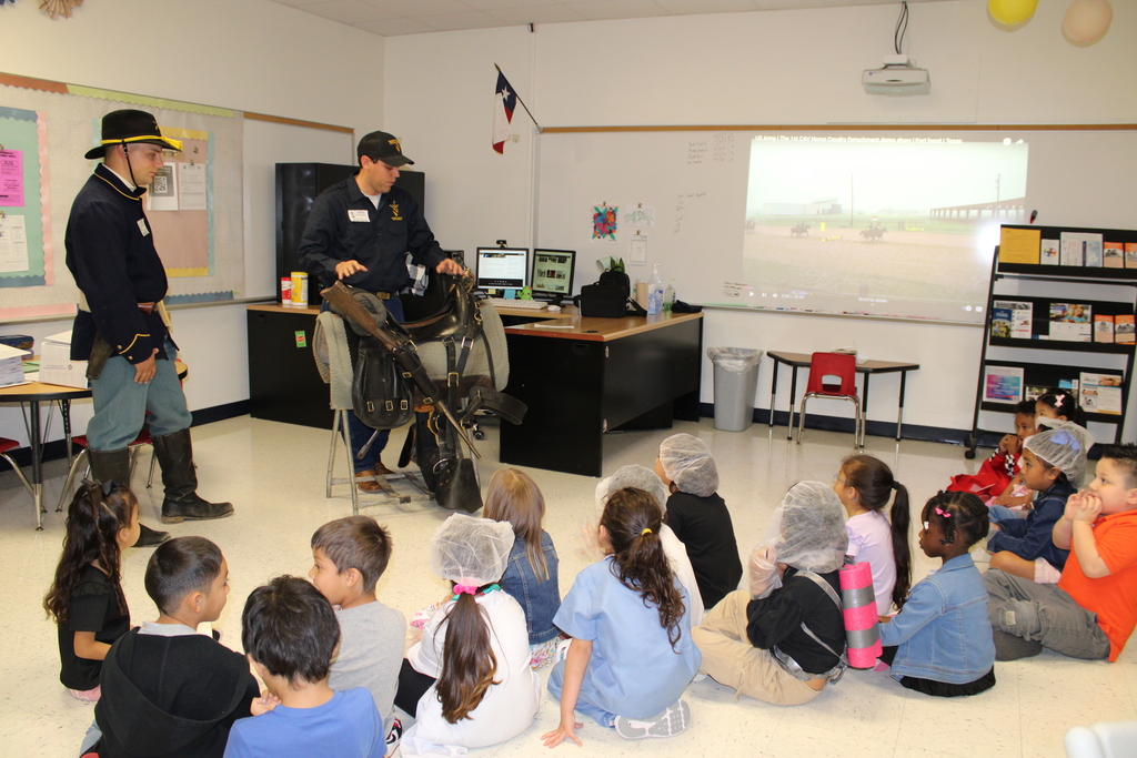 1st Cav soldiers from the horse detachment talking with students about what they do. 
