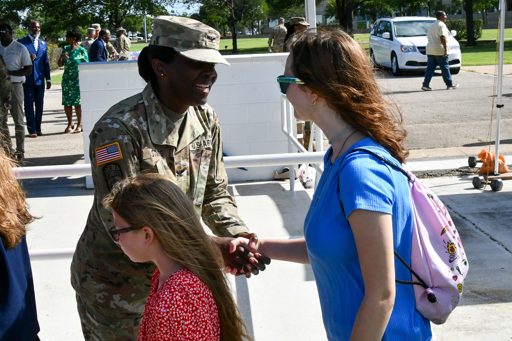 Army colonel shaking hands with student