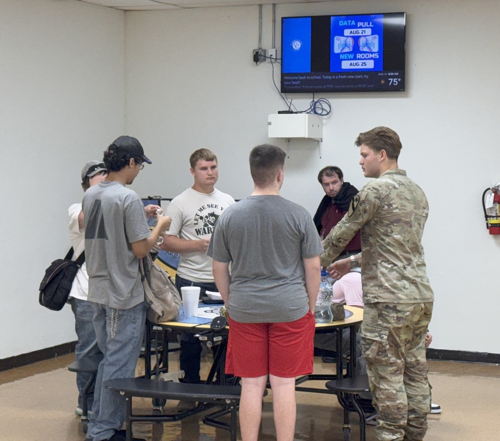 Students listening to soldier