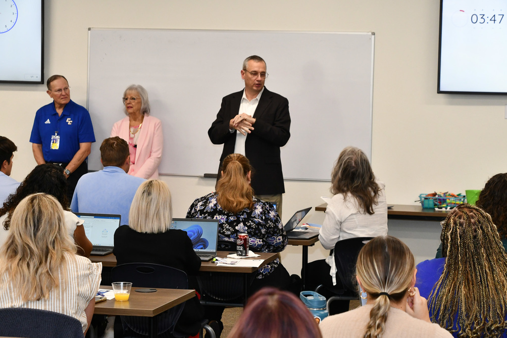 Superintendent addressing a crowd of teachers