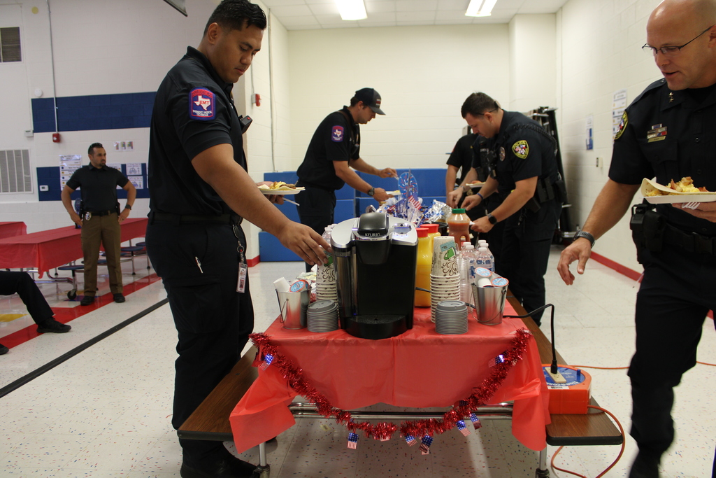 Police and Firefighters grab breakfast from buffet table