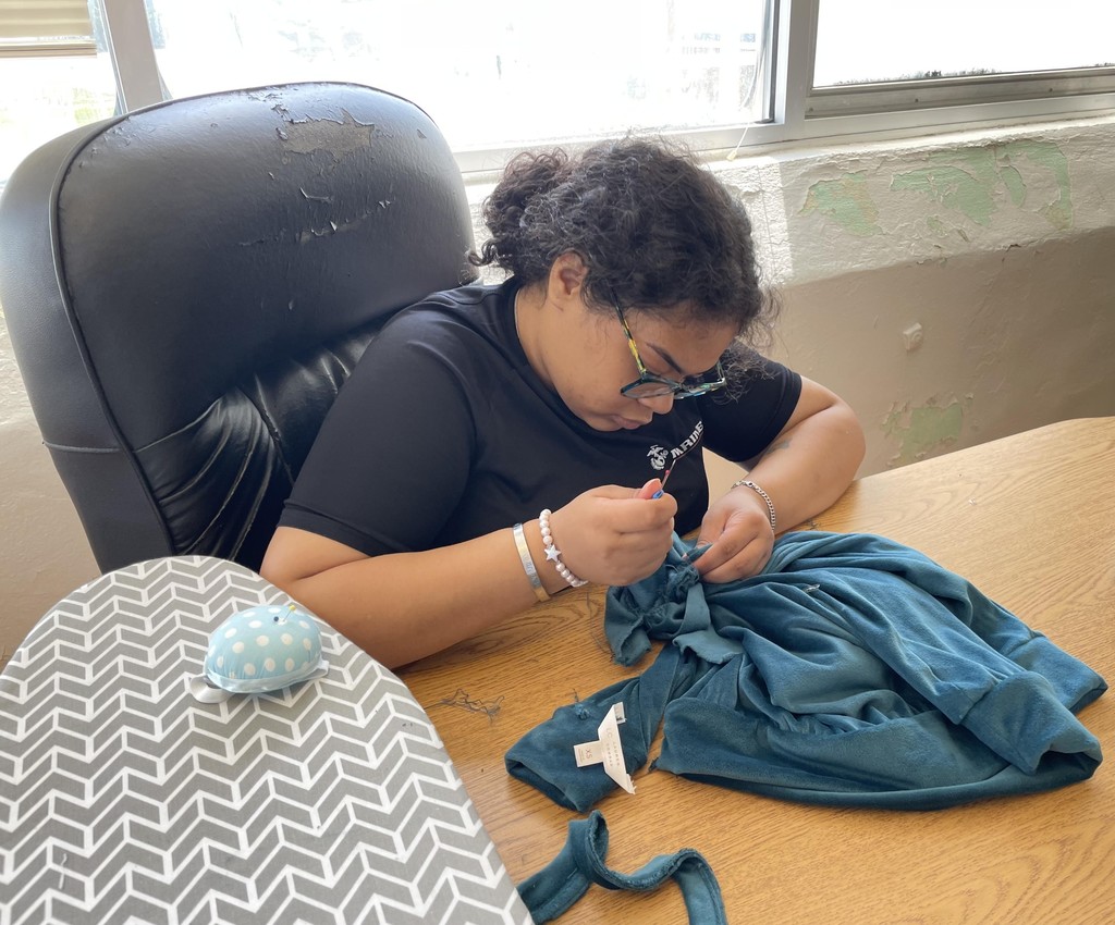 Student showing sewing project