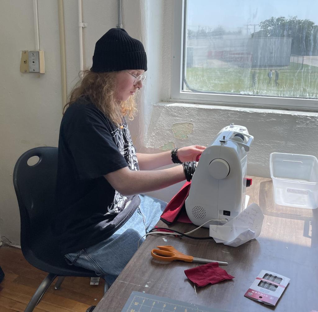 Student showing sewing project
