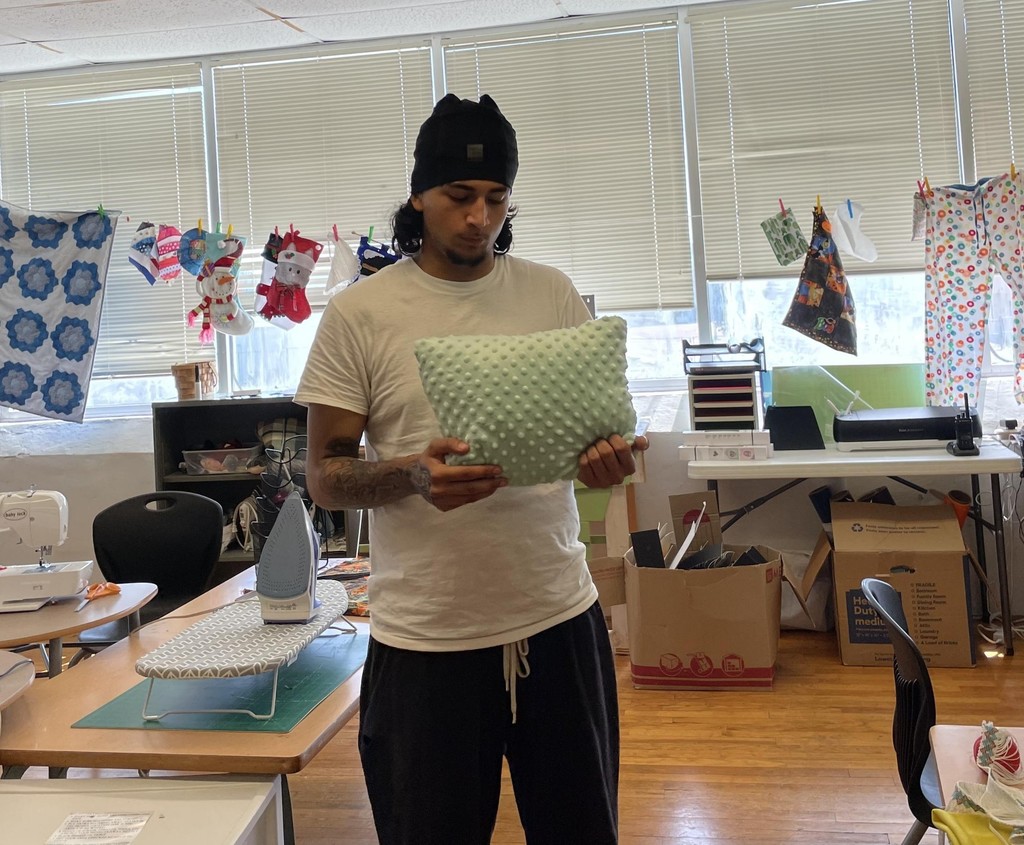 Student showing sewing project