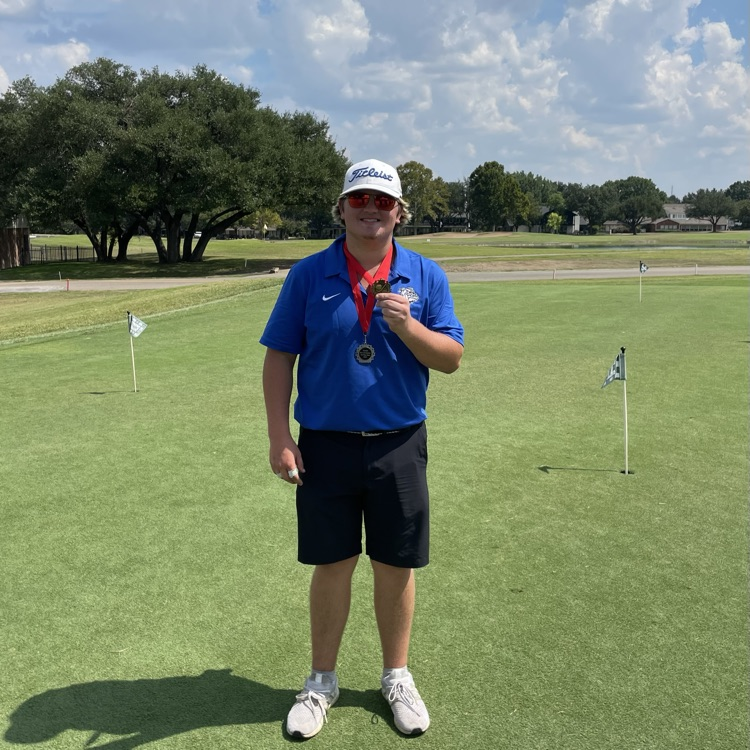 boy holding medal 