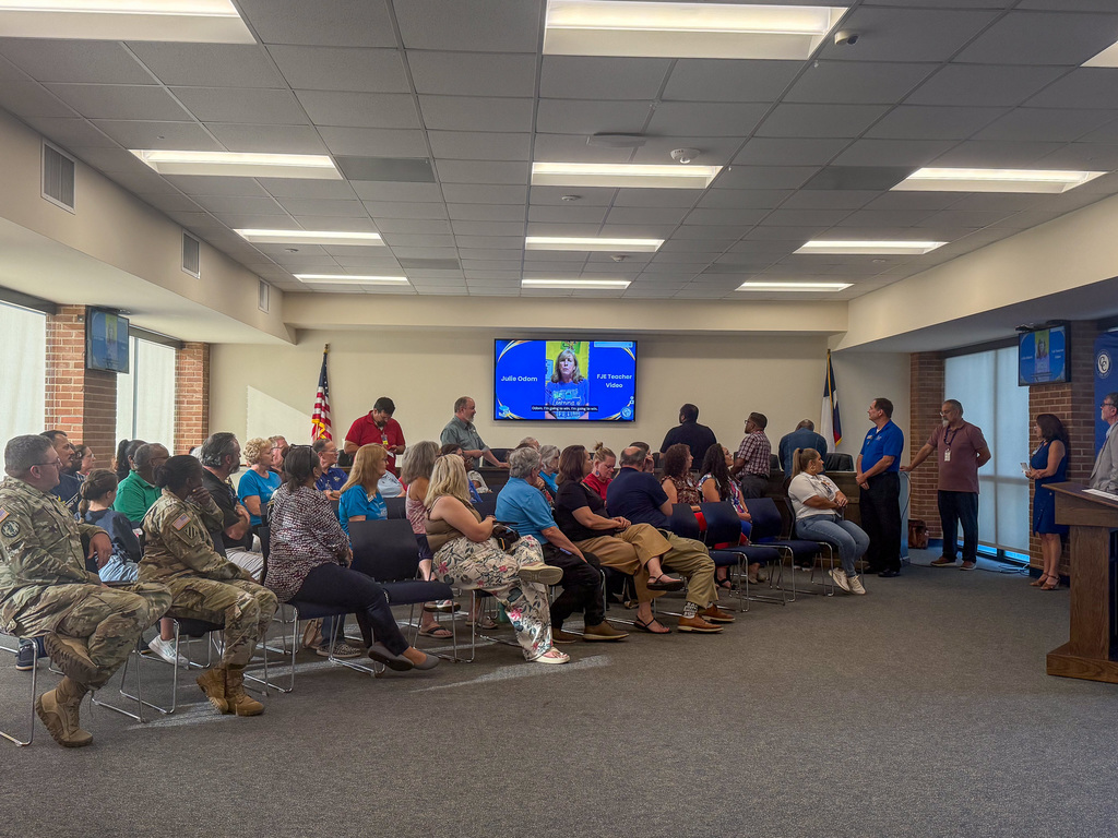 A group of people looking at a screen