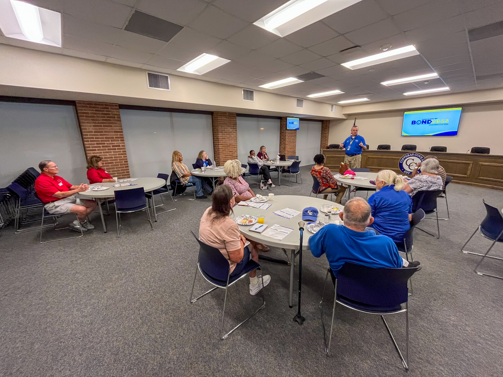 A group of people listening to a presentation