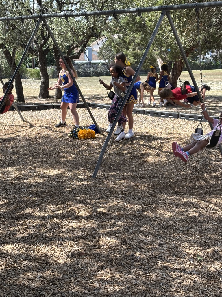 CCJHS Cheerleaders playing on the playground with elementary students