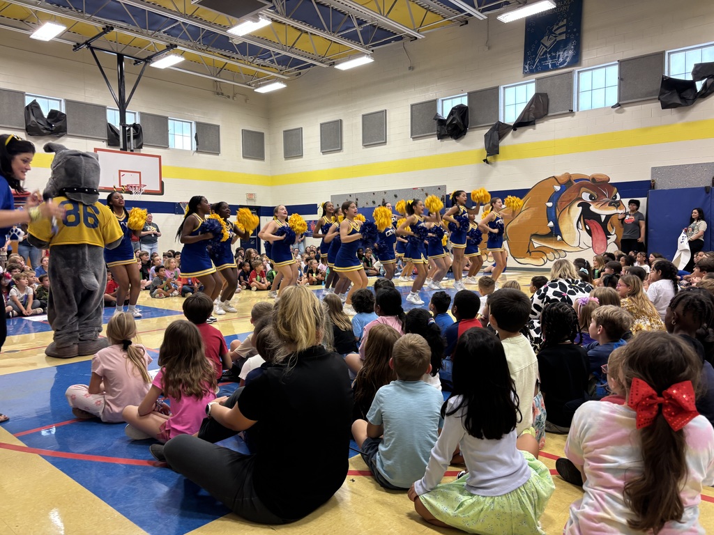 Cheerleaders performing to kindergarten students at Martin Walker Elementary