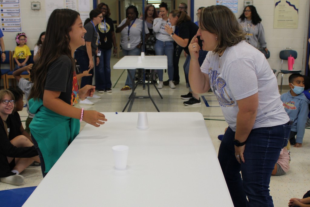 Ms. Kinney and student playing game