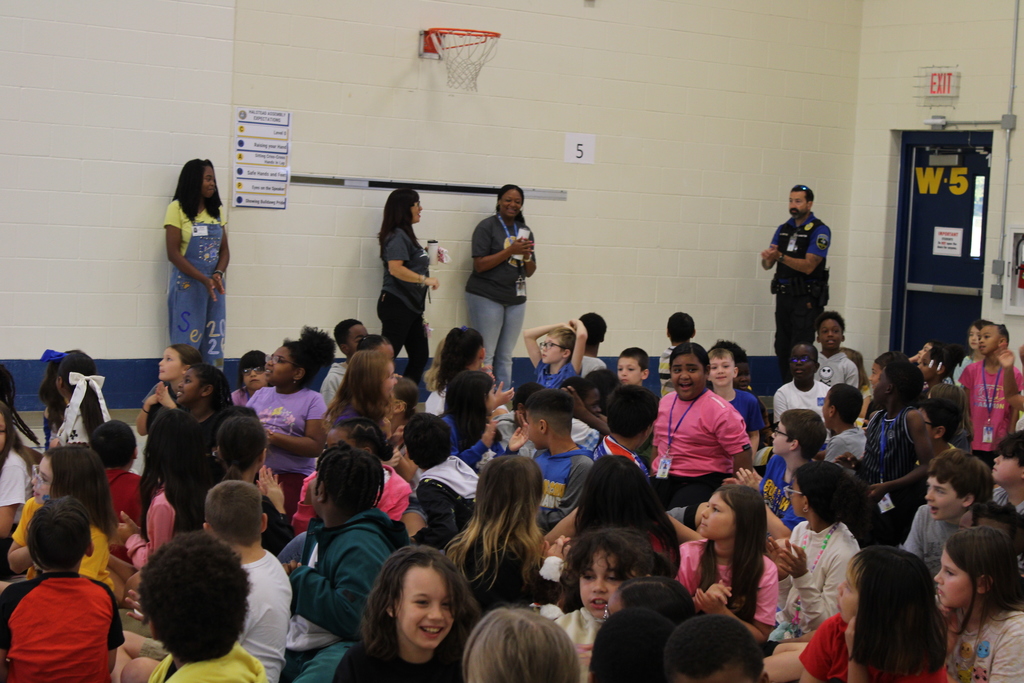 Students sit and listen to pep rally