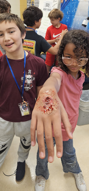 Theater students showing off their wound make-up skills.