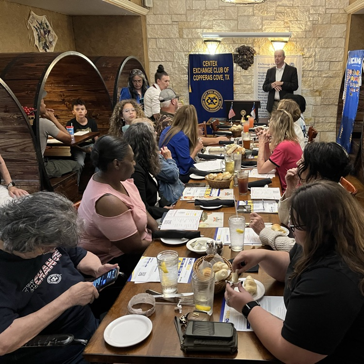 A man presenting to an audience in a restaurant