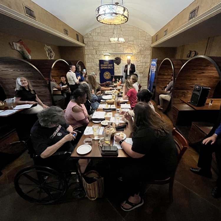 A man presenting to an audience in a restaurant