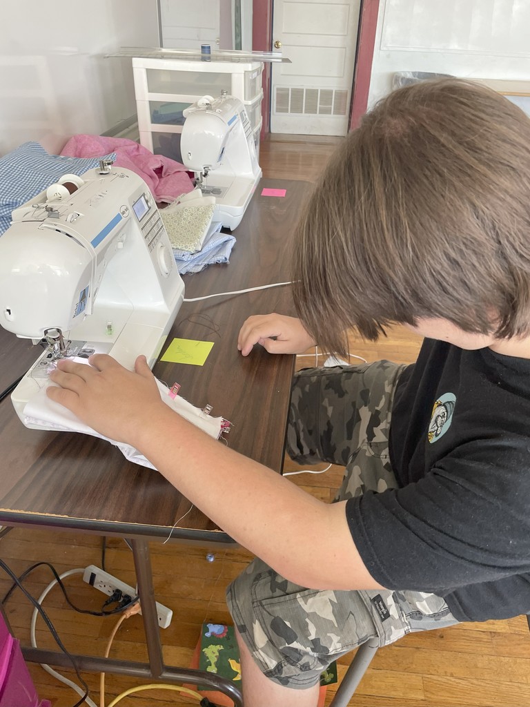 Student at sewing machine working
