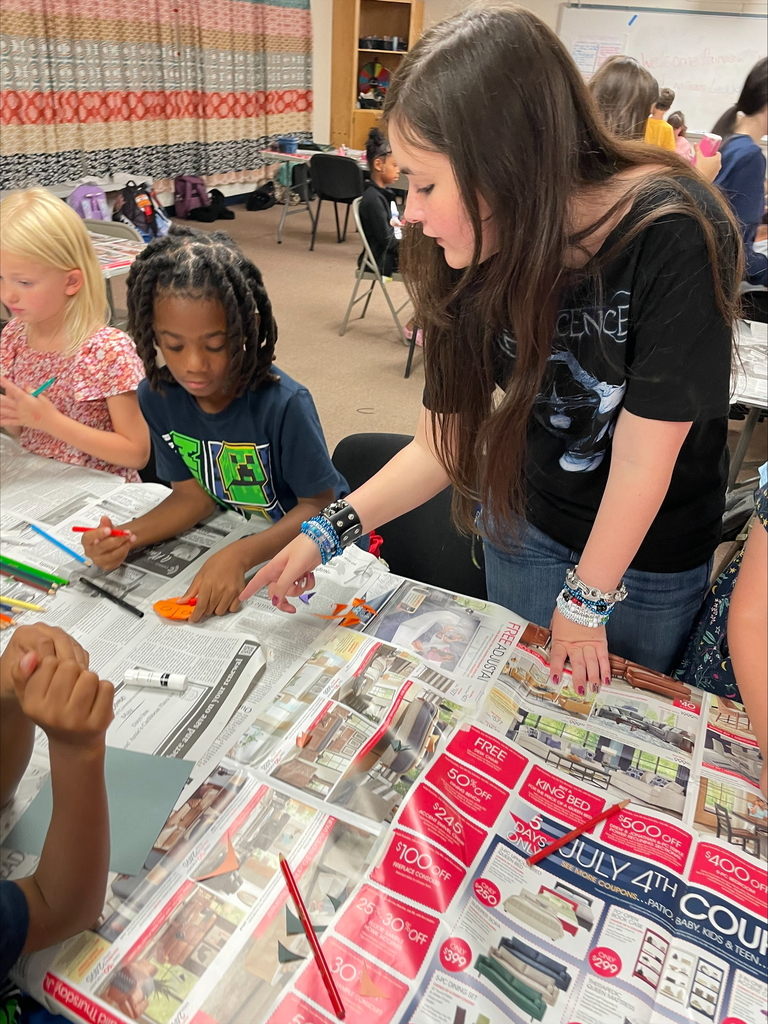 High school students teaching elementary students.