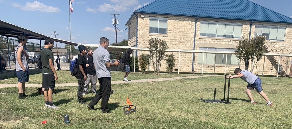 Picture of Mr. Brown giving instructions during Sled Push challenge.