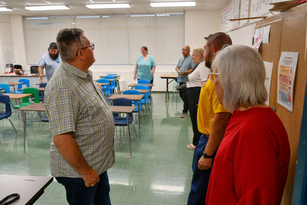 A group of people touring a classroom