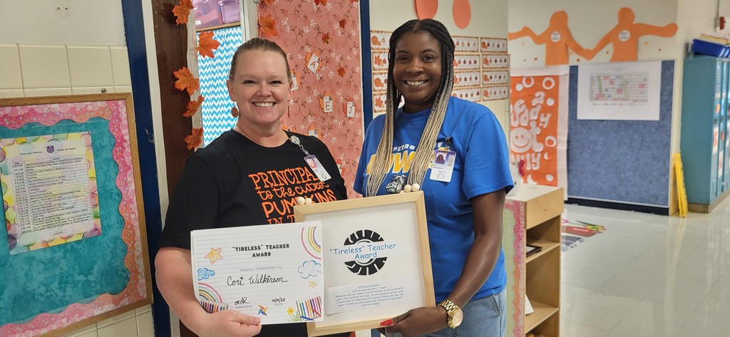 Ms. Peacock and Mrs. Richardson accepting Mrs. Wilkerson's Tireless Teacher Award
