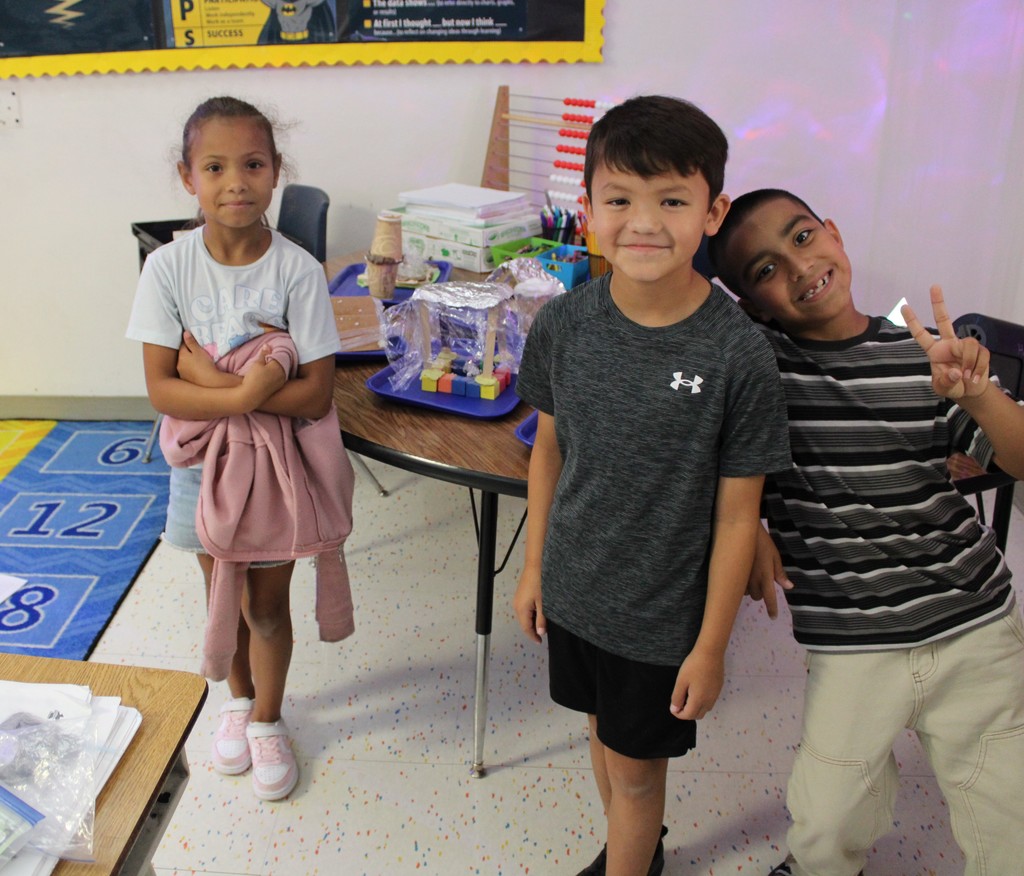 3 Students pose with finished animal shelter