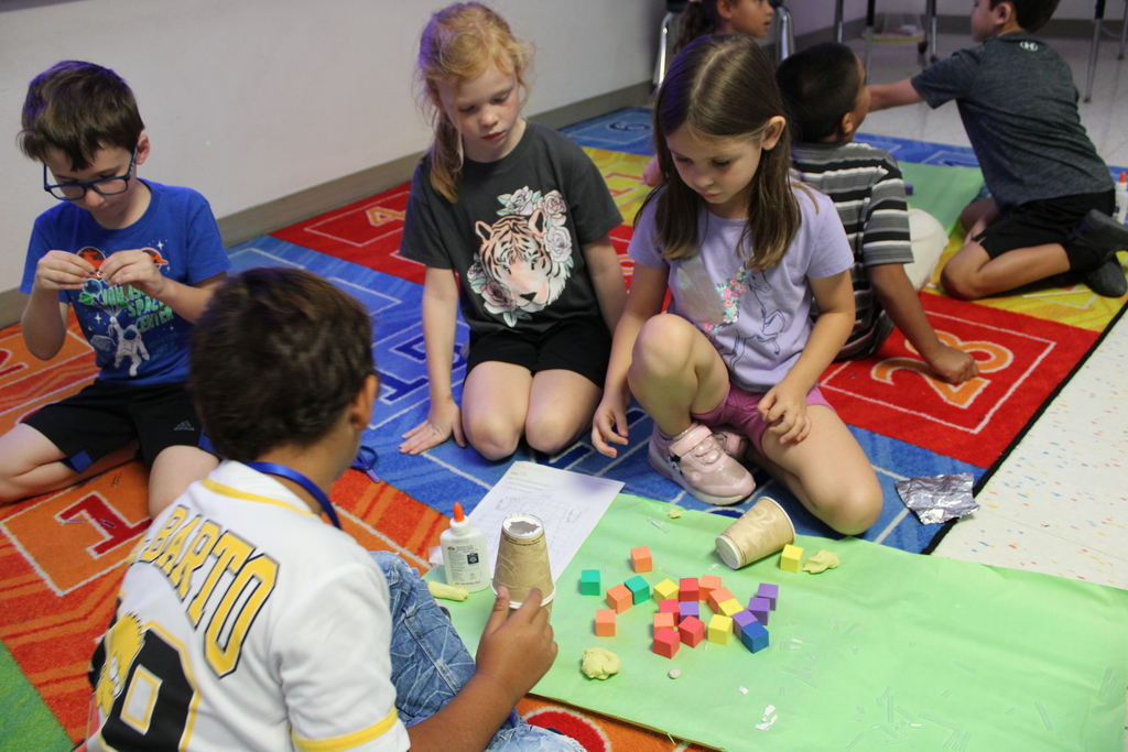 4 students gather supplies 