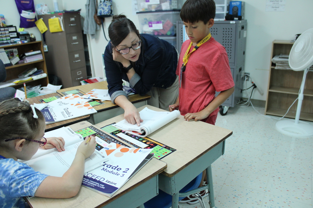 Ms. Klein helps student at desk
