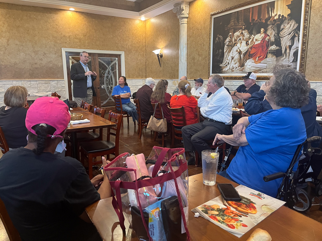 A man speaking to a group at a restaurant