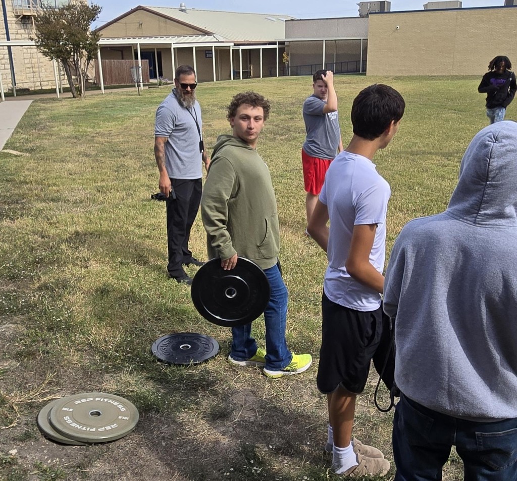 Picture of students participating in weight carry fitness challenge.