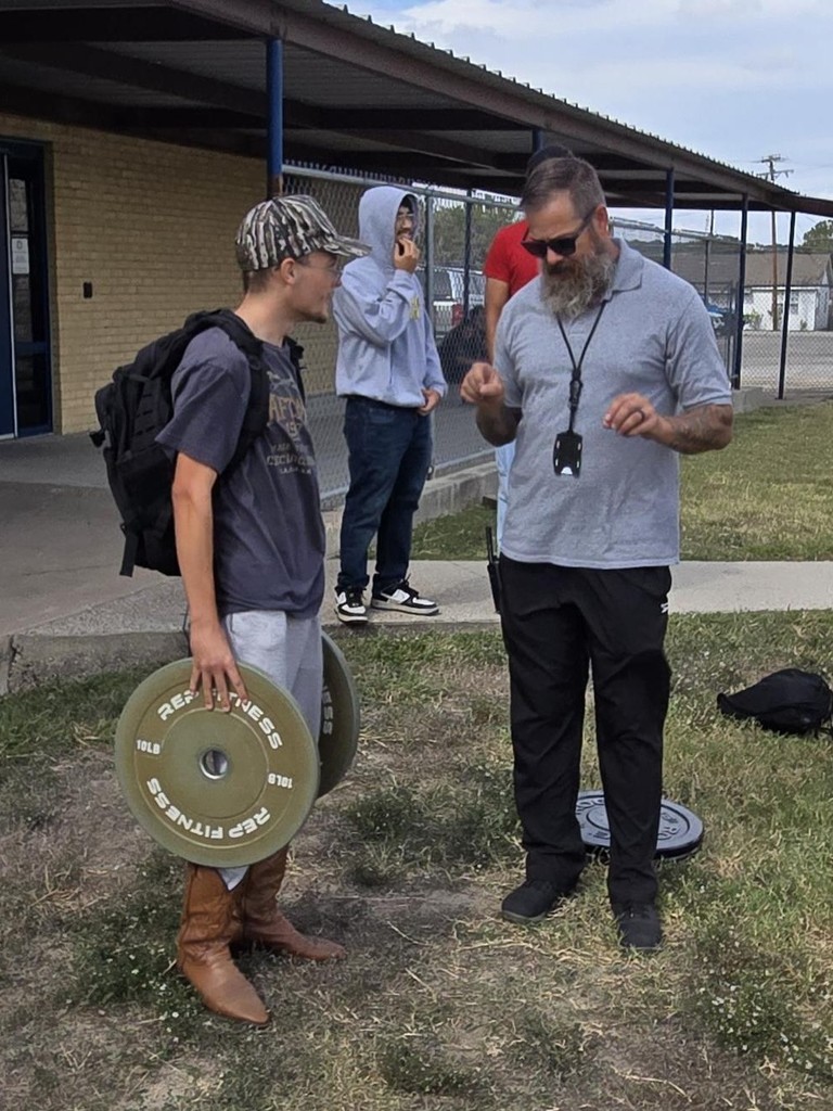 Picture of Mr. Brown explaining the weight carry fitness challenge.