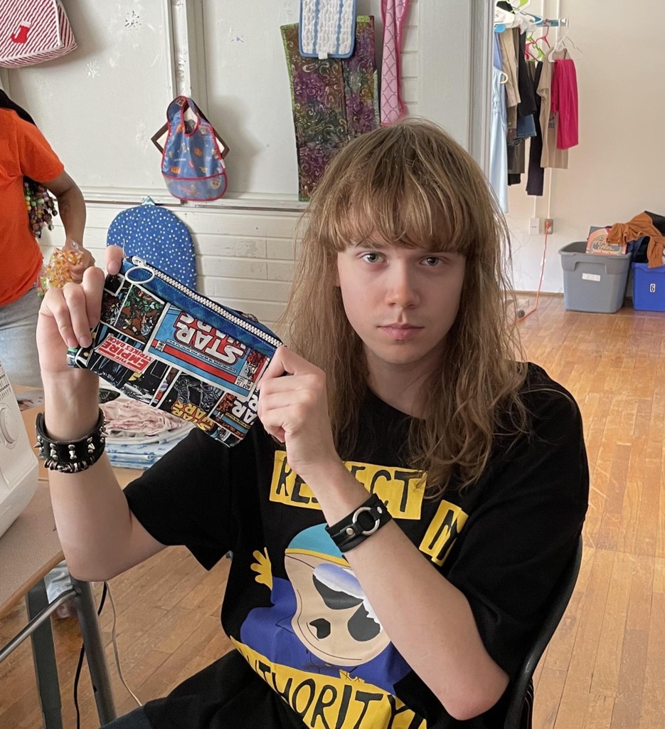 Picture of Colton with a  finished a lined zipper bag