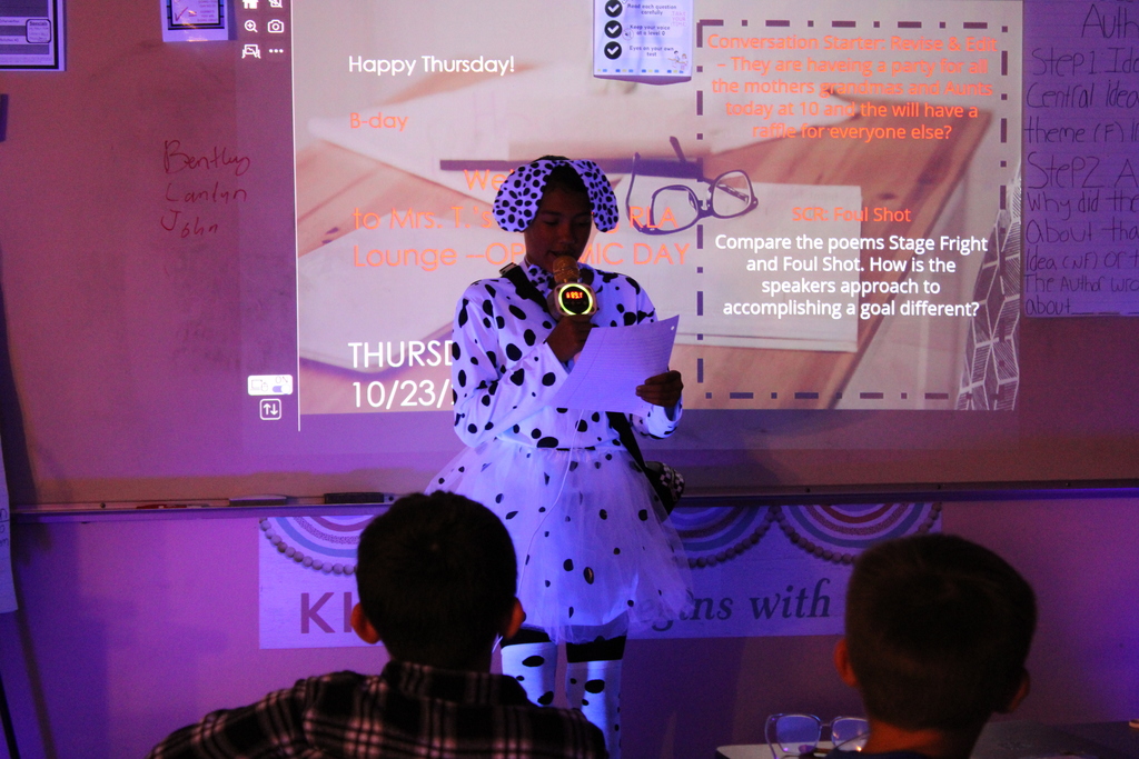 Student at front of the class reads their poem.