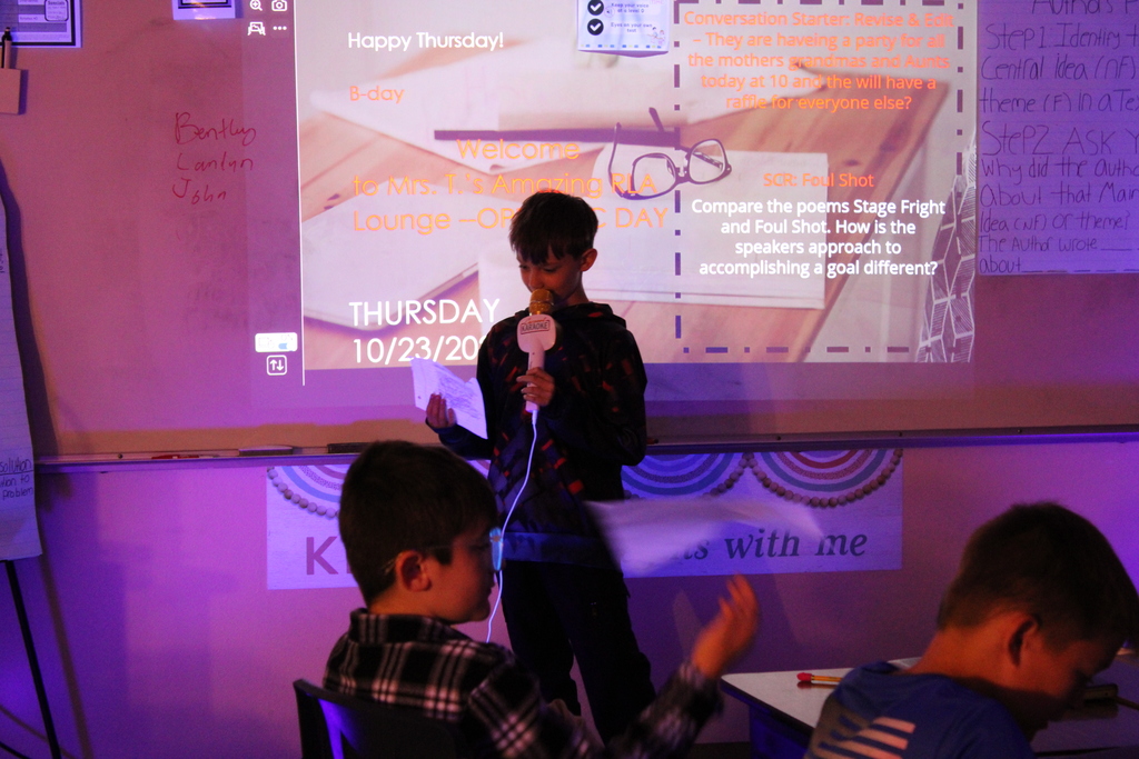 Student at front of the class reads their poem.