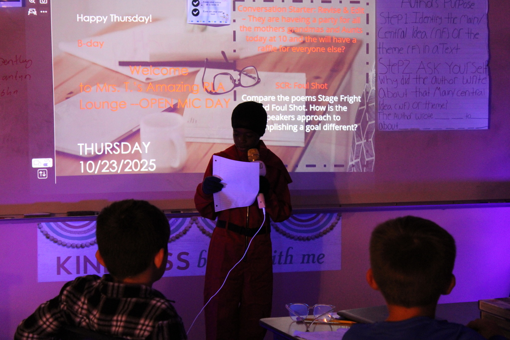 Student at front of the class reads their poem.