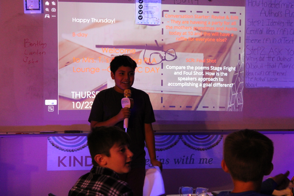 Student at front of the class reads their poem.