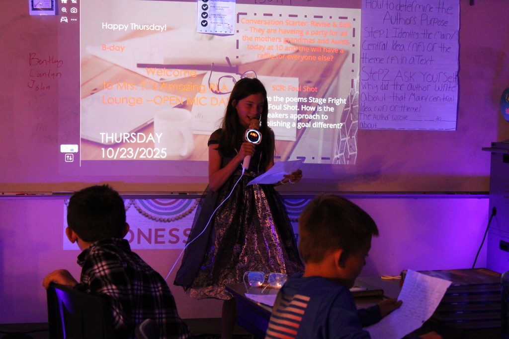 Student at front of the class reads their poem.