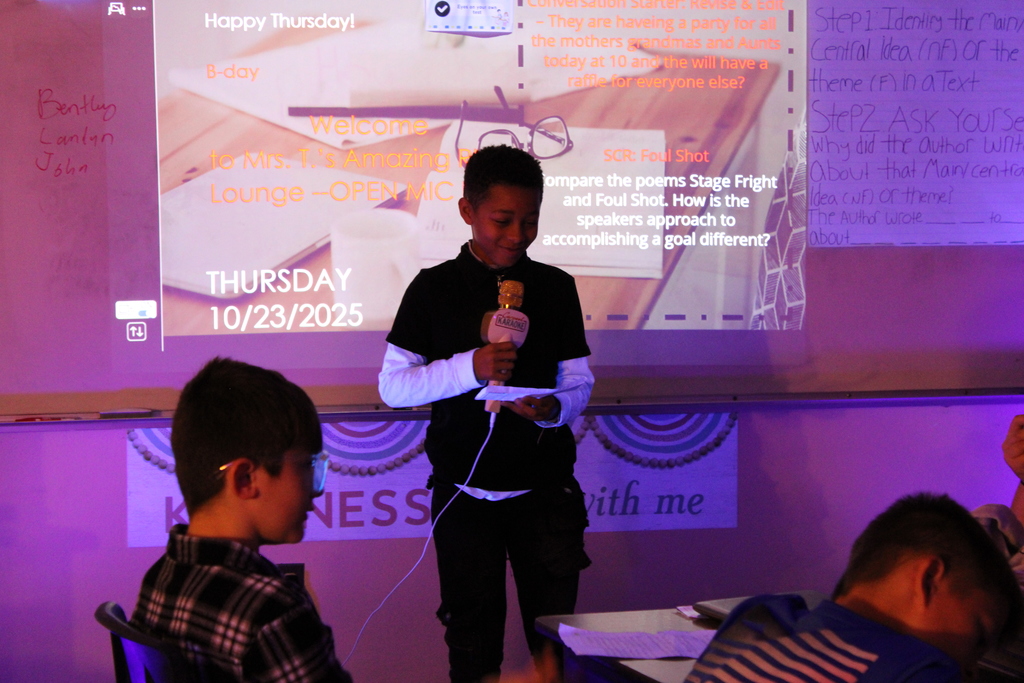 Student at front of the class reads their poem.