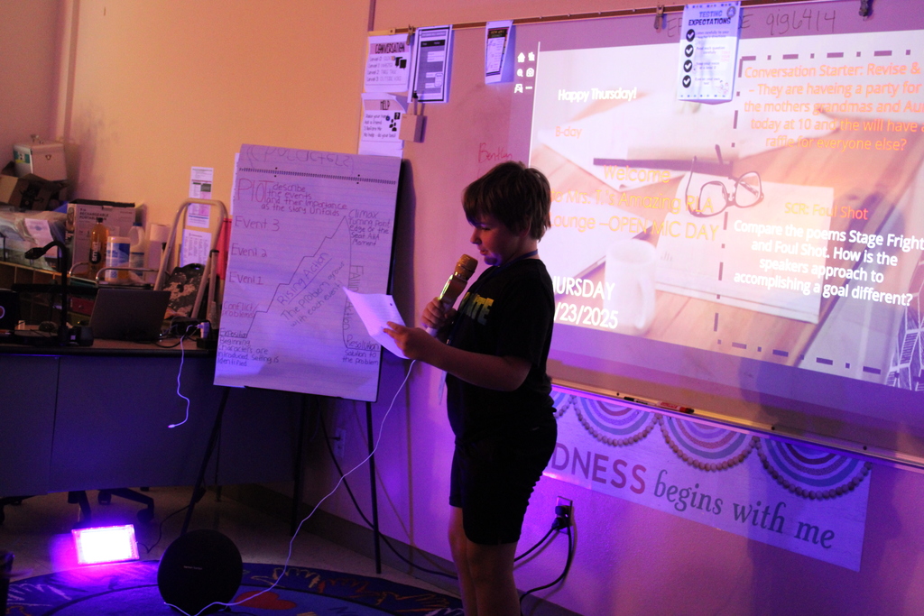 Student at front of the class reads their poem