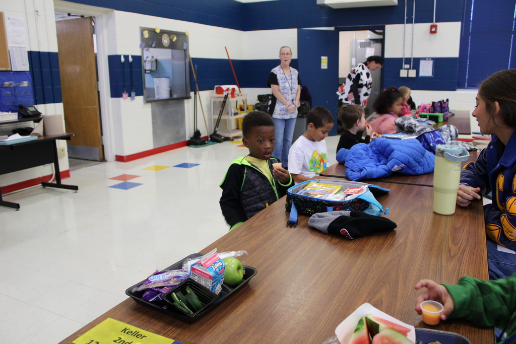 student sitting drinking sample milk