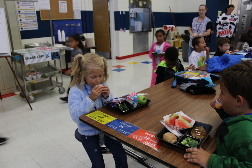 Student sitting down drinking sample