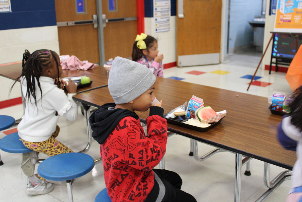Student sitting down drinking sample
