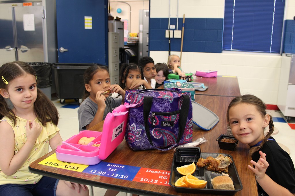Students smile while eating lunch