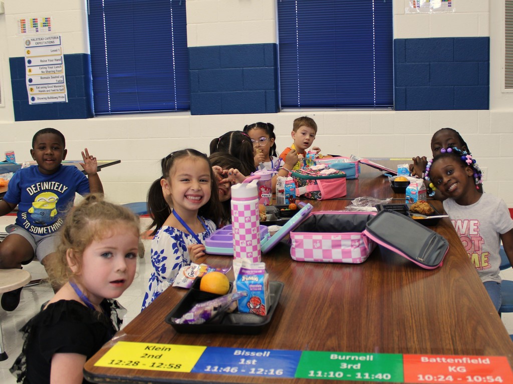 Students smile while eating lunch