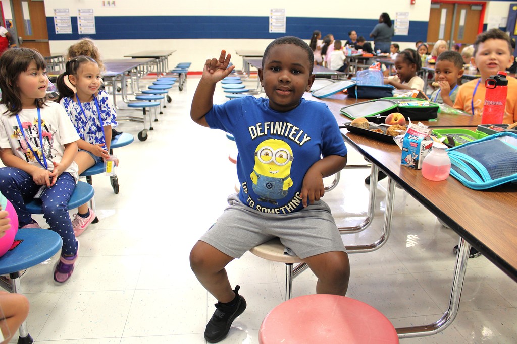 Students smile while eating lunch