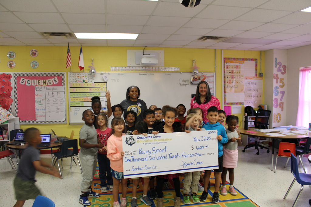 Dr. Sweeney and Ms. Smarts class accepts grant check on behalf of Ms. Smart