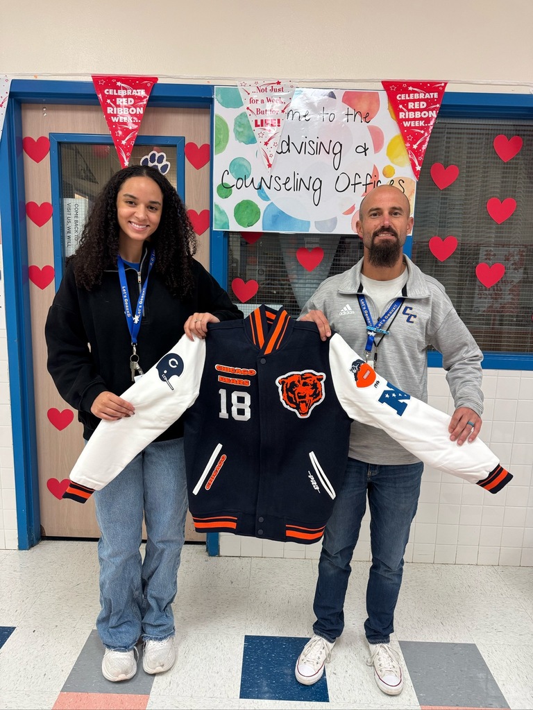 Two counselors smiling with a jacket