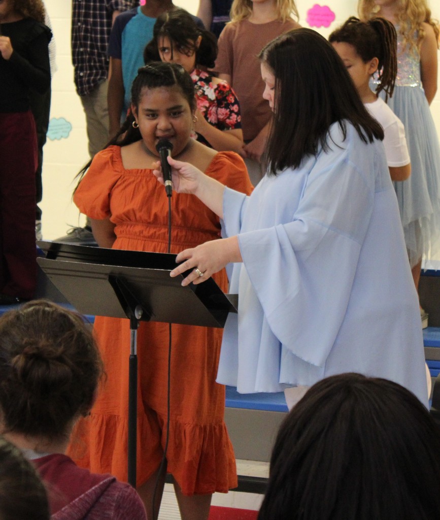 3rd grade music program students speaking on microphone