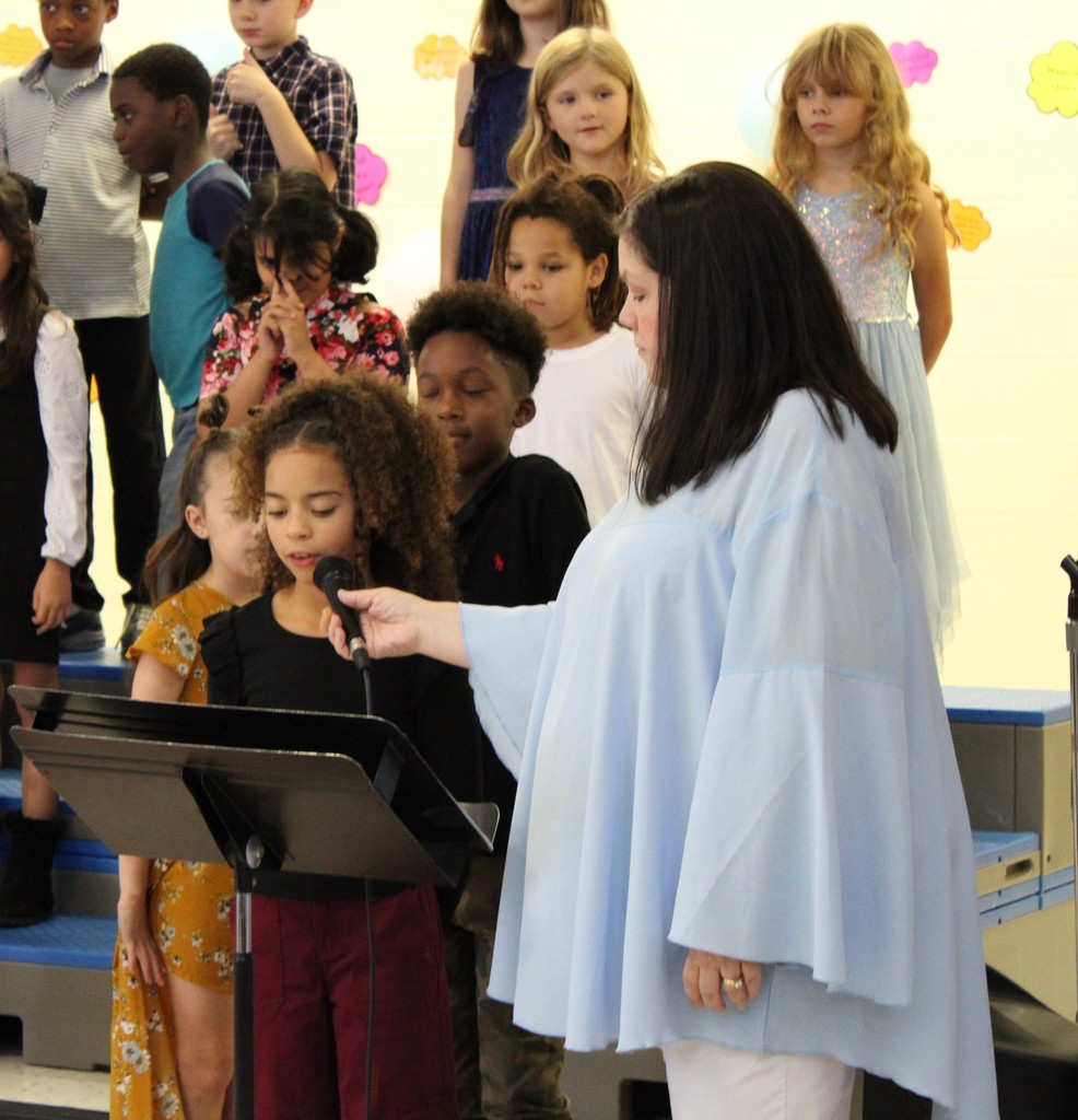 3rd grade music program students speaking on microphone