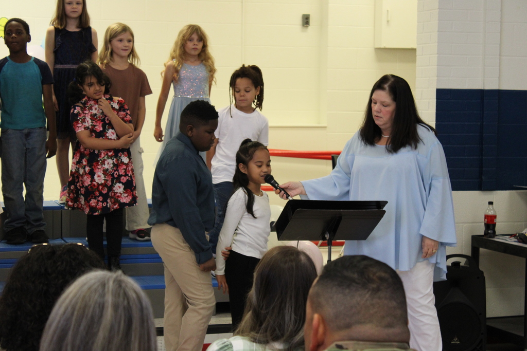 3rd grade music program students speaking on microphone