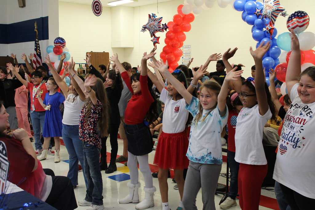 Students end dance performance waving arms