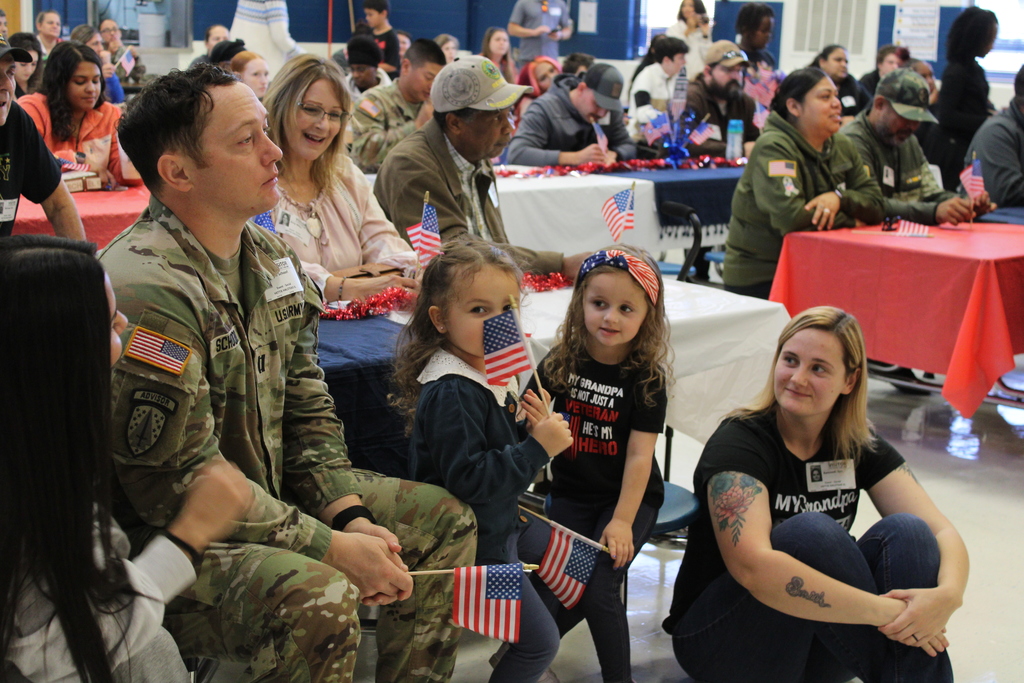Parents and Children with American flags wait for music program